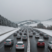 Snow in Tuscany, cars in traffic on a highway, winter season